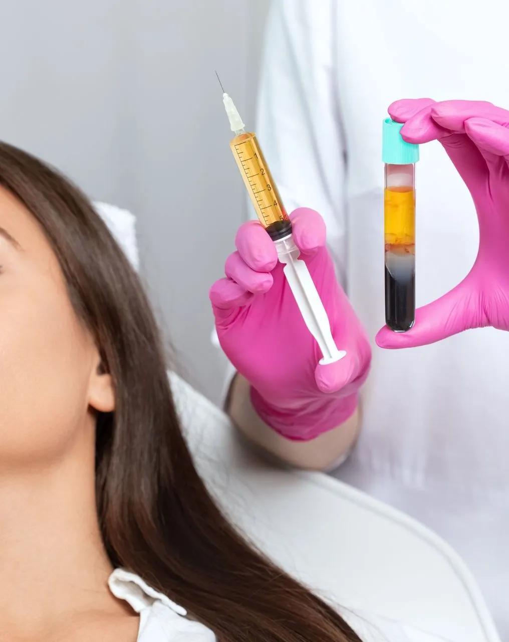 A woman is getting an injection from a doctor who is holding a syringe and a test tube.