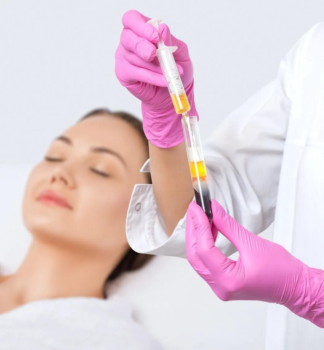 A woman is getting an injection from a doctor wearing pink gloves.